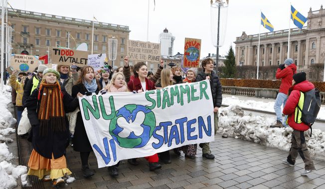 Climate activists of the youth-led organization Auroras march in Stockholm, Sweden, Friday, Nov. 25, 2022. A crane-operated camera was used to strike climate activists (not pictured) who interrupted a celebrity dance competition finale in Sweden on Friday. Writing on banner reads in Swedish &amp;quot;Now we sue the State&amp;quot; (Christine Ohlsson/TT News Agency via AP)