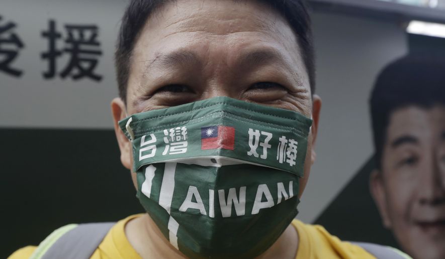 A supporter wears a mask patterned with the Taiwan national flag and slogan reading &amp;quot;Taiwan is awesome&amp;quot; during an election campaign in Taipei, Taiwan, Sunday, Nov. 20, 2022. Taiwan will hold local elections on November 26. (AP Photo/Chiang Ying-ying)