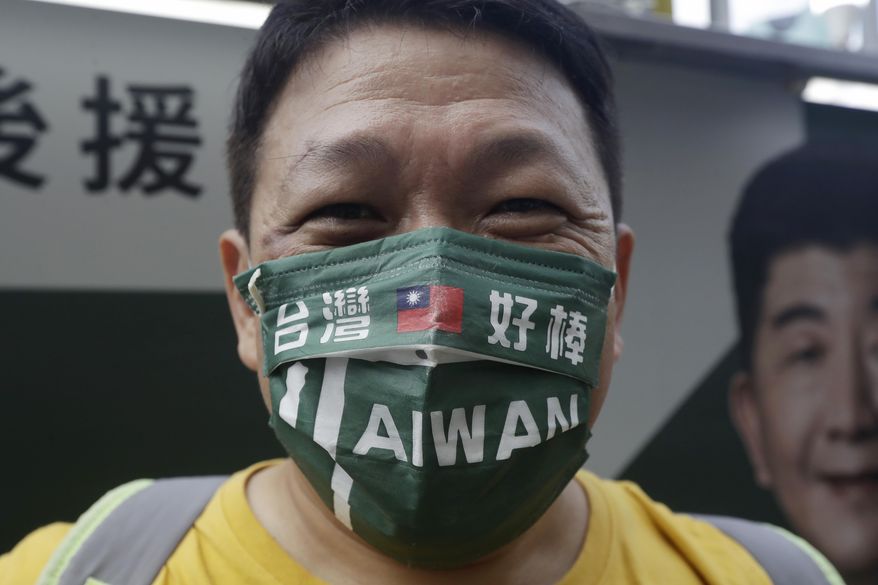A supporter wears a mask patterned with the Taiwan national flag and slogan reading &amp;quot;Taiwan is awesome&amp;quot; during an election campaign in Taipei, Taiwan, Sunday, Nov. 20, 2022. Taiwan will hold local elections on November 26. (AP Photo/Chiang Ying-ying)