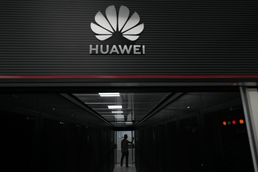 A technician stands at the entrance to a Huawei 5G data server center at the Guangdong Second Provincial General Hospital in Guangzhou, in southern China&#x27;s Guangdong province on Sept. 26, 2021. The U.S. is banning the sale of communications equipment made by Chinese companies Huawei and ZTE and restricting the use of some China-made video surveillance systems, citing an “unacceptable risk” to national security. The 5-member Federal Communications Commission said Friday, Nov. 25, 2022 it has voted unanimously to adopt new rules that will block the importation or sale of certain technology products that pose security risks. (AP Photo/Ng Han Guan)