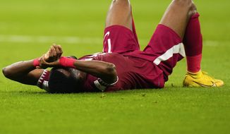 Qatar&#39;s Ismail Mohamad lies after his side&#39;s 1-3 lost against Senegal during a World Cup group A soccer match at the Al Thumama Stadium in Doha, Qatar, Friday, Nov. 25, 2022. (AP Photo/Petr Josek)