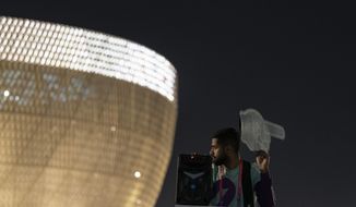 Osama, 21 years-old, from Palestine works as a street marshal prior to the World Cup group G soccer match between Brazil and Serbia, at the Lusail Stadium in Lusail, Qatar, Thursday, Nov. 24, 2022. The World Cup 2010 in South Africa had Shakira. The 1998 World Cup in France had Ricky Martin. In Qatar, the tune that nests itself in the head is the incessant chanting of street marshals, better knows as Last Mile Marshals. Seated all over Doha on high chairs more commonly used by lifeguards at swimming pools, these migrant workers have become a staple of the Middle East&#39;s first World Cup. (AP Photo/Moises Castillo)