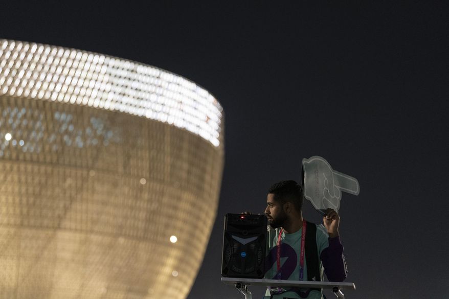 Osama, 21 years-old, from Palestine works as a street marshal prior to the World Cup group G soccer match between Brazil and Serbia, at the Lusail Stadium in Lusail, Qatar, Thursday, Nov. 24, 2022. The World Cup 2010 in South Africa had Shakira. The 1998 World Cup in France had Ricky Martin. In Qatar, the tune that nests itself in the head is the incessant chanting of street marshals, better knows as Last Mile Marshals. Seated all over Doha on high chairs more commonly used by lifeguards at swimming pools, these migrant workers have become a staple of the Middle East&#x27;s first World Cup. (AP Photo/Moises Castillo)