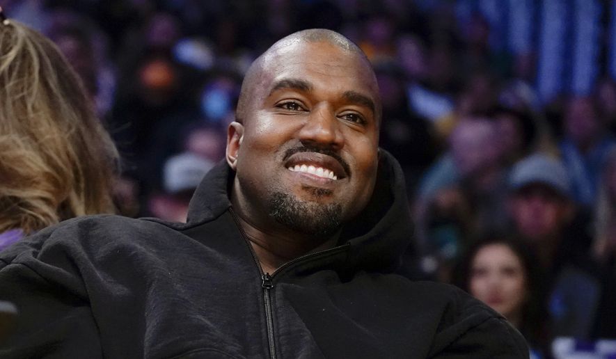 Kanye West watches the first half of an NBA basketball game between the Washington Wizards and the Los Angeles Lakers in Los Angeles, on March 11, 2022. (AP Photo/Ashley Landis, File)
