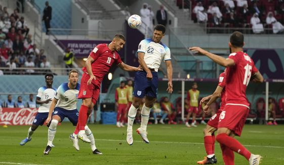 England&#39;s Jude Bellingham, centre, scores his side&#39;s opening goal during the World Cup group B soccer match between England and Iran at the Khalifa International Stadium in Doha, Qatar, Monday, Nov. 21, 2022. (AP Photo/Alessandra Tarantino)