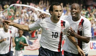USA&#x27;s Landon Donovan, left, celebrates with DaMarcus Beasley after scoring a penalty kick against Mexico during the second half of the Gold Cup Soccer game, Sunday, June 24, 2007, in Chicago.  Donovan and Beasley were elected Saturday, Nov. 26, 2022, to the U.S. National Soccer Hall of Fame and will be inducted May 6 along with Lauren Cheney Holiday.(AP Photo/Nam Y. Huh, File)