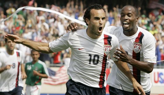 USA&#39;s Landon Donovan, left, celebrates with DaMarcus Beasley after scoring a penalty kick against Mexico during the second half of the Gold Cup Soccer game, Sunday, June 24, 2007, in Chicago.  Donovan and Beasley were elected Saturday, Nov. 26, 2022, to the U.S. National Soccer Hall of Fame and will be inducted May 6 along with Lauren Cheney Holiday.(AP Photo/Nam Y. Huh, File)