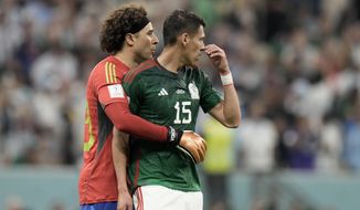 Mexico&#39;s goalkeeper Guillermo Ochoa embraces teammate Hector Moreno, right, at the end of the World Cup group C soccer match between Argentina and Mexico, at the Lusail Stadium in Lusail, Qatar, Saturday, Nov. 26, 2022. Argentina won 2-0. (AP Photo/Moises Castillo)