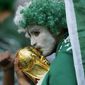 A Saudi Arabia fan kisses a copy of the World Cup trophy prior of the World Cup group C soccer match between Poland and Saudi Arabia, at the Education City Stadium in Al Rayyan , Qatar, Saturday, Nov. 26, 2022. (AP Photo/Francisco Seco)
