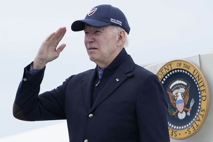 President Joe Biden returns a salute before boarding Air Force One at Nantucket Memorial Airport in Nantucket, Mass., Sunday, Nov. 27, 2022. Biden is heading back to Washington after spending the Thanksgiving Day holiday in Nantucket with family. (AP Photo/Susan Walsh)