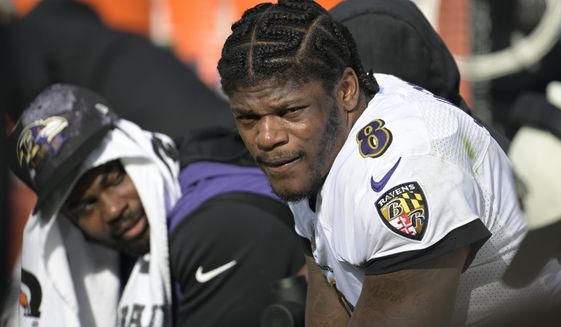 Baltimore Ravens quarterback Lamar Jackson (8) watches from the bench during the first half of an NFL football game against the Jacksonville Jaguars, Sunday, Nov. 27, 2022, in Jacksonville, Fla. (AP Photo/Phelan M. Ebenhack)