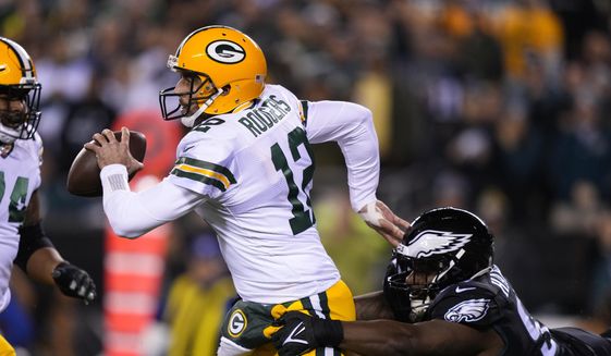 Green Bay Packers quarterback Aaron Rodgers (12) is pressured by Philadelphia Eagles&#39; Javon Hargave during the first half of an NFL football game, Sunday, Nov. 27, 2022, in Philadelphia. (AP Photo/Matt Slocum) **FILE**