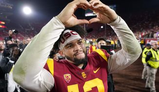 Southern California quarterback Caleb Williams gestures to fans after USC defeated Notre Dame 38-27 an NCAA college football game Saturday, Nov. 26, 2022, in Los Angeles. (AP Photo/Mark J. Terrill)