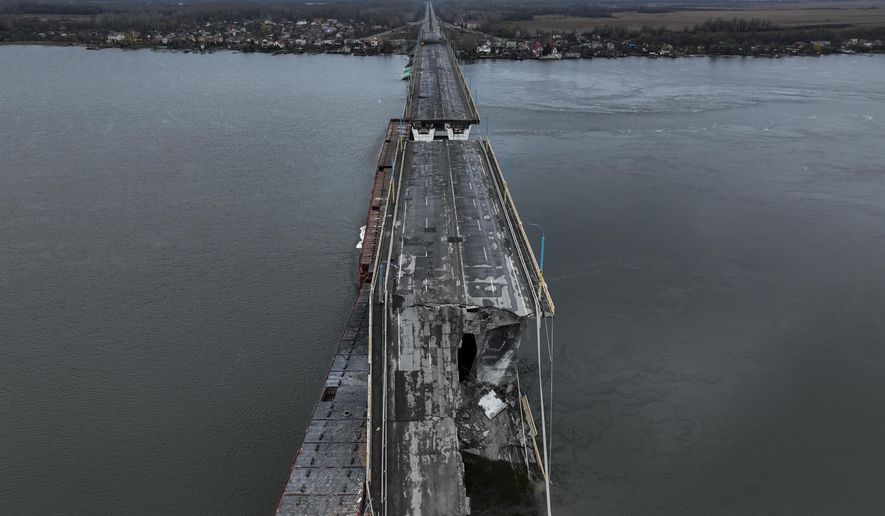 General view of the damaged Antonivsky Bridge in Kherson, Ukraine, Sunday, Nov. 27, 2022. The bridge, the main crossing point over the Dnipro river in Kherson, was destroyed by Russian troops in earlier November, after Kremlin&#39;s forces withdrew from the southern city. (AP Photo/Bernat Armangue)