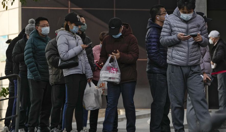 Residents stand in line to enter a store which controls the flow of shoppers in Beijing, Sunday, Nov. 27, 2022. Protests against China&#39;s overzealous zero-COVID policies in Shanghai continued on Saturday afternoon, after police cleared away hundreds of protesters in the early morning hours with force and pepper spray. (AP Photo/Andy Wong)