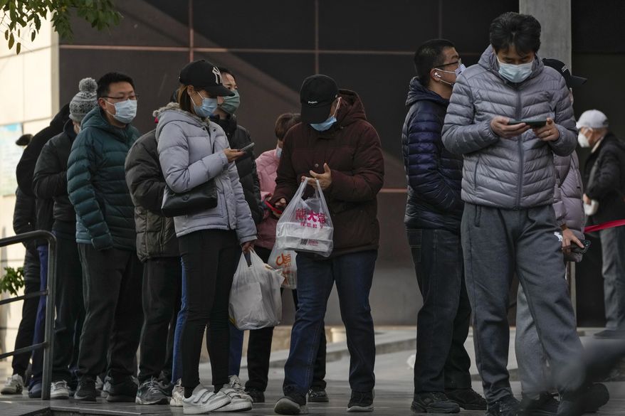 Residents stand in line to enter a store which controls the flow of shoppers in Beijing, Sunday, Nov. 27, 2022. Protests against China&#x27;s overzealous zero-COVID policies in Shanghai continued on Saturday afternoon, after police cleared away hundreds of protesters in the early morning hours with force and pepper spray. (AP Photo/Andy Wong)