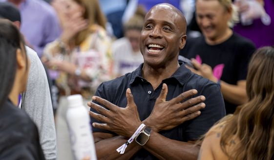 FILE - Former San Francisco Giants slugger Barry Bonds attends an NBA basketball game between the Portland Trail Blazers and Sacramento Kings in Sacramento, Calif., Wednesday, Oct. 19, 2022. Hall of Famers Chipper Jones, Greg Maddux, Jack Morris and Ryne Sandberg are among 16 members of the contemporary baseball era committee that will meet Sunday to consider the Cooperstown fate of an eight-man ballot that includes Barry Bonds, Roger Clemens and Rafael Palmeiro. (AP Photo/José Luis Villegas, File)