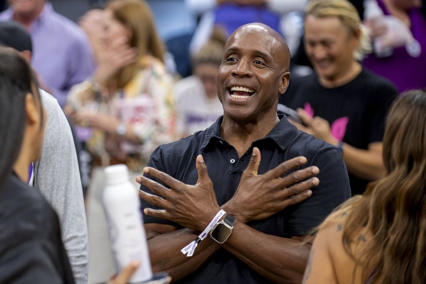 FILE - Former San Francisco Giants slugger Barry Bonds attends an NBA basketball game between the Portland Trail Blazers and Sacramento Kings in Sacramento, Calif., Wednesday, Oct. 19, 2022. Hall of Famers Chipper Jones, Greg Maddux, Jack Morris and Ryne Sandberg are among 16 members of the contemporary baseball era committee that will meet Sunday to consider the Cooperstown fate of an eight-man ballot that includes Barry Bonds, Roger Clemens and Rafael Palmeiro. (AP Photo/José Luis Villegas, File)
