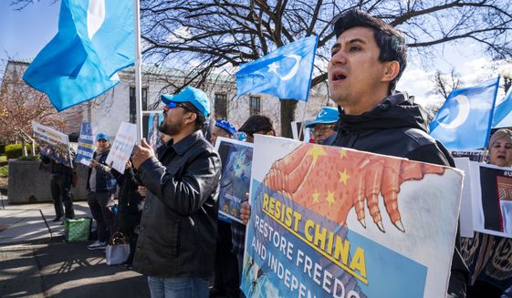 Amanalla Kashgari, of Ashburn Va., with the East Turkistan Youth Congress, protests against China and in support of the Uyghur people, in the wake of the Urumqi fire in China, Monday, Nov. 28, 2022, outside the State Department in Washington. (AP Photo/Jacquelyn Martin)