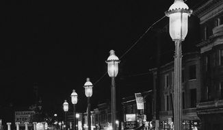 Gas lamps illuminate St. Louis&#39; Gaslight Square on April 2, 1962. &quot;Gaslighting&quot; — mind manipulating, grossly misleading, downright deceitful — is Merriam-Webster&#39;s word of 2022. (AP Photo/JMH, File)