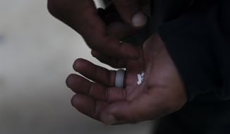 A homeless addict holds pieces of fentanyl in Los Angeles, Thursday, Aug. 18, 2022. Use of the powerful synthetic opioid that is cheap to produce and is often sold as is or laced in other drugs, has exploded. Because it&#39;s 50 times more potent than heroin, even a small dose can be fatal. It has quickly become the deadliest drug in the nation, according to the Drug Enforcement Administration. (AP Photo/Jae C. Hong)