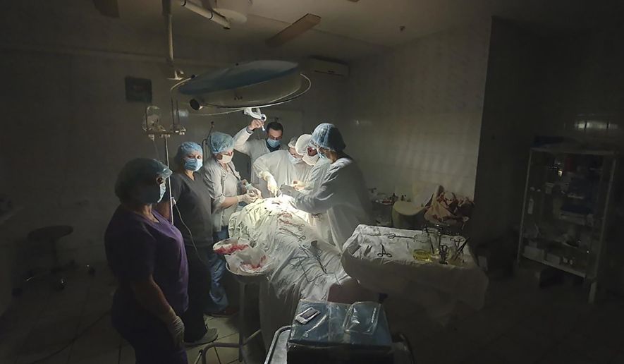 This photo mad available by Ukrainian doctor Oleh Duda shows the moment when lights at a hospital went out as he was performing complicated, dangerous surgery on a bleeding patient at the hospital in western city of Lviv, Ukraine, Tuesday, Nov. 15, 2022. Russia&#39;s devastating strikes on Ukraine&#39;s power grid have strained and disrupted the country’s health care system, already battered by years of corruption, mismanagement, the COVID-19 pandemic and nine months of war. (Oleh Duda via AP)