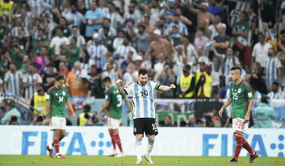 Argentina&#39;s Lionel Messi celebrates after his team won the World Cup group C soccer match between Argentina and Mexico, at the Lusail Stadium in Lusail, Qatar, Saturday, Nov. 26, 2022. (AP Photo/Hassan Ammar)