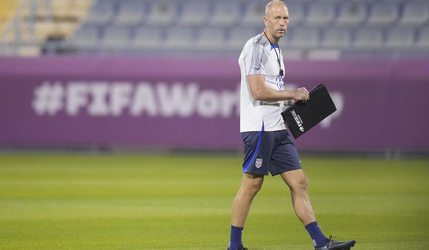 Head coach Gregg Berhalter of the United States walks on the pitch during an official training session at Al Gharafa SC Stadium, in Doha, Sunday, Nov. 27, 2022. (AP Photo/Ashley Landis)