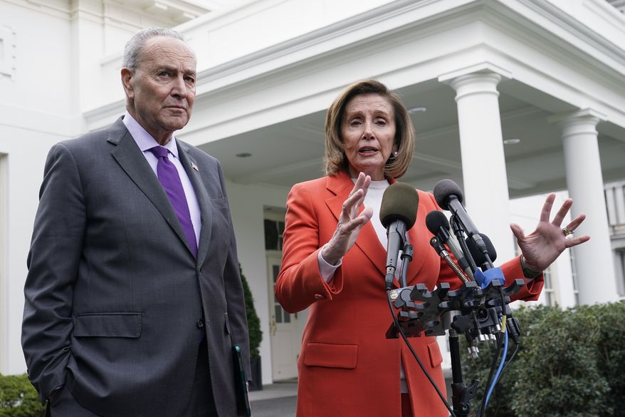Senate Majority Leader Chuck Schumer of N.Y., right, listens as House Speaker Nancy Pelosi of Calif., left, speaks to reporters at the White House in Washington, Tuesday, Nov. 29, 2022, about their meeting with President Joe Biden. (AP Photo/Susan Walsh) **FILE**