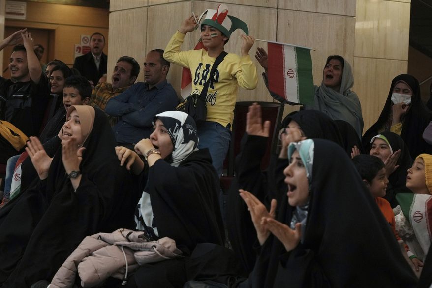 Iranian fans watch their national soccer team play against the United States in Qatar's World Cup, on a giant screen at a cultural center in Tehran, Iran, early Wednesday, Nov. 30, 2022. The U.S. team's victory over Iran at the World Cup on Tuesday was closely watched across the Middle East, where the two nations have been engaged in a cold war for over four decades and where many blame one or both for the region's woes. (AP Photo/Vahid Salemi)