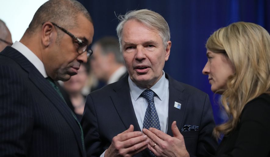 Britain&#39;s Foreign Secretary James Cleverly, left, talks with Finland&#39;s Foreign Minister Pekka Haavisto, center, and Canada&#39;s Foreign Minister Melanie Joly during the first day of the meeting of NATO Ministers of Foreign Affairs, in Bucharest, Romania, Tuesday, Nov. 29, 2022. (AP Photo/Andreea Alexandru)