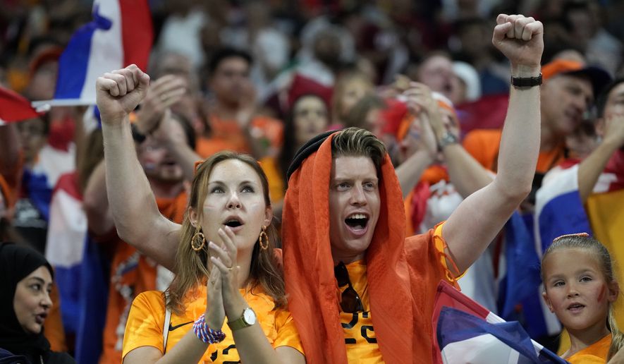Fans cheer before the World Cup group A soccer match between the Netherlands and Qatar, at the Al Bayt Stadium in Al Khor , Qatar, Tuesday, Nov. 29, 2022. (AP Photo/Lee Jin-man)