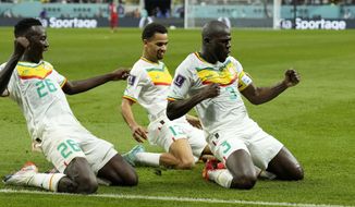 Senegal&#39;s Kalidou Koulibaly, right, celebrates with teammates scoring his side&#39;s second goal during the World Cup group A soccer match between Ecuador and Senegal, at the Khalifa International Stadium in Doha, Qatar, Tuesday, Nov. 29, 2022. (AP Photo/Francisco Seco)