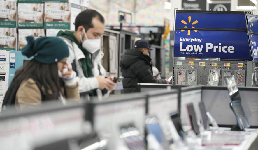 Signs advertise deals and low prices at a Walmart in Secaucus, N.J., Tuesday, Nov. 22, 2022. On Tuesday the Conference Board reports on U.S. consumer confidence for November. (AP Photo/Seth Wenig, File)