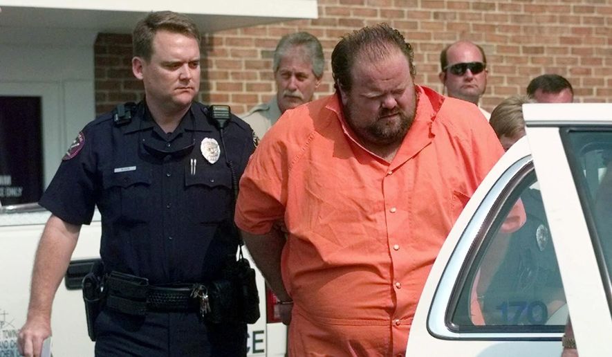Officials escort murder suspect Alan Eugene Miller away from the Pelham City Jail in Alabama, Aug. 5, 1999. Miller was sentenced to death after being convicted of a 1999 workplace rampage. According to the terms of a settlement agreement approved on Monday, Nov. 28, 2022, Alabama will not seek another lethal injection date for Miller, an inmate whose September execution had been halted because of problems establishing an intravenous line. (AP Photo/Dave Martin, File)