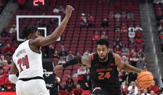 Maryland forward Donta Scott (24) attempts to get past Louisville forward Jae&#39;Lyn Withers (24) during the first half of an NCAA college basketball game in Louisville, Ky., Tuesday, Nov. 29, 2022. (AP Photo/Timothy D. Easley)