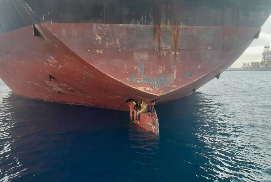 In this photo released by Spain&#x27;s Maritime Safety and Rescue Society on Tuesday Nov. 29, 2022, three men are photographed on an oil tanker anchored in the port of the Canary Islands, Spain. Spain’s Maritime Rescue Service says it has rescued three stowaways traveling on a ship’s rudder in the Canary Islands after the vessel sailed there from Nigeria. The men were found on the Alithini II oil tanker at the Las Palmas port. (Salvamento Maritimo via AP)