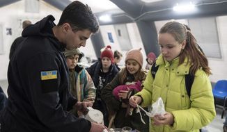 A rescue worker makes tea for children at the heating tent &amp;quot;Point of Invincibly&amp;quot; in Bucha, Ukraine, Monday, Nov. 28, 2022. (AP Photo/Evgeniy Maloletka)