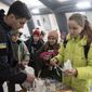 A rescue worker makes tea for children at the heating tent &amp;quot;Point of Invincibly&amp;quot; in Bucha, Ukraine, Monday, Nov. 28, 2022. (AP Photo/Evgeniy Maloletka)