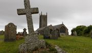 A Christian cross grave headstone stands in the graveyard of St Eval Norman medieval church in St Eval, Wadebridge, U.K. on July 4th, 2022. (File photo credit: Daniel Bond via Shutterstock)