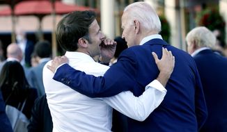 French President Emmanuel Macron whispers to U.S. President Joe Biden following their dinner at the G7 Summit in Elmau, Germany, June 26, 2022. Macron is heading to Washington for the first state visit of Biden’s presidency—a reviving of diplomatic pageantry that had been put on hold because of the COVID-19 pandemic. (AP Photo/Susan Walsh, File)