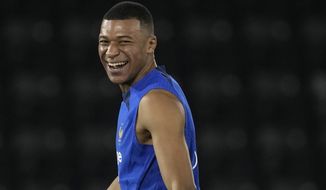 France&#39;s Kylian Mbappe, jokes with teammates during a training session at the Jassim Bin Hamad stadium in Doha, Qatar, Monday, Nov. 28, 2022. France will play in the World Cup against Tunisia on Nov. 30. (AP Photo/Christophe Ena)