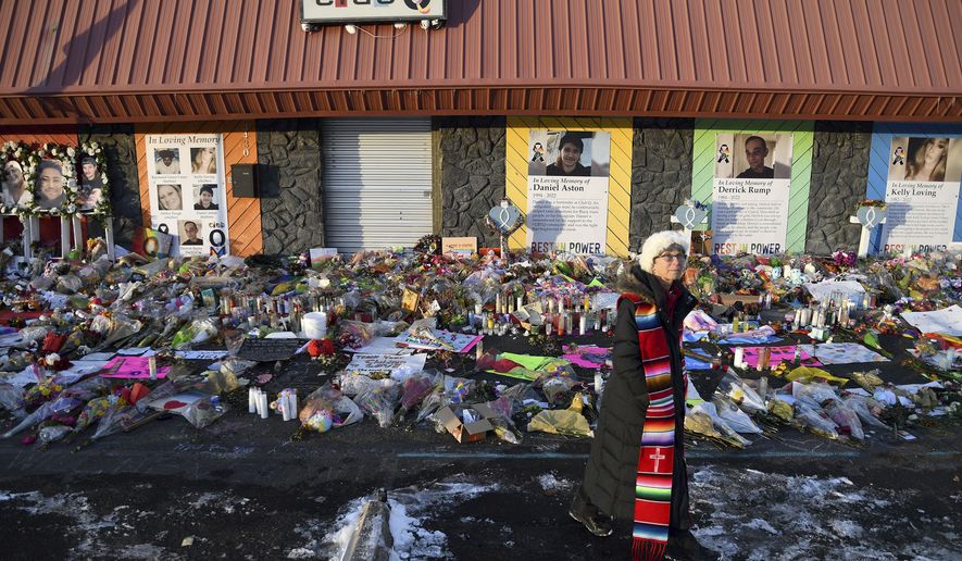 Rev. Paula Stecker of the Christ the King Lutheran Church stands in front of a memorial set up outside Club Q following last week&#39;s mass shooting at the gay nightclub in Colorado Springs, Colo., Tuesday, Nov. 29, 2022.  (AP Photo/Thomas Peipert)