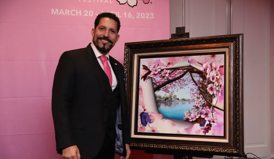 D.C. officials unveiled Tuesday, Nov. 29, the official artwork of the 2023 National Cherry Blossom Festival, which will return in person for the second straight year this spring. The artwork by Orlando Quevedo (pictured here) depicts the Tidal Basin and the Jefferson Memorial through a tunnel of cherry blossoms. (Courtesy of National Cherry Blossom Festival)