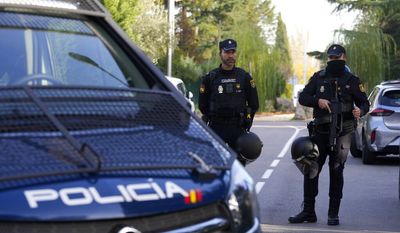 Police officers stand guard as they cordon off the area next to the Ukrainian Embassy in Madrid, Spain, Wednesday, Nov. 30, 2022. Spain&#x27;s Interior Ministry says police are investigating reports of a blast at the Ukrainian Embassy in Madrid. The ministry says police were told an employee at the embassy was slightly injured handling a letter in what it described as &quot;a deflagration.&quot; (AP Photo/Paul White)