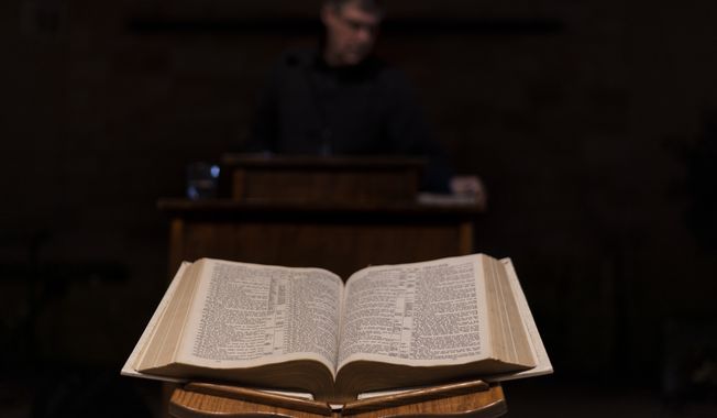 A Bible sits open as Pastor Rick Mannon stands at the pulpit at Calvary Assembly of God in Wilson, Wis., Wednesday, Nov. 16, 2022. (AP Photo/David Goldman) ** FILE **
