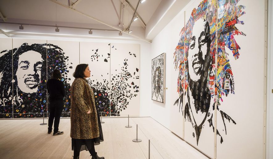 Images of the late reggae pioneer Bob Marley appear at the press launch for the exhibit &quot;Bob Marley One Love Experience&quot; at the Saatchi Gallery in London on Feb. 2, 2022. The multi-room exhibit will open at Ovation Hollywood in Los Angeles on Jan. 27. The 15,000-square foot experience includes previously unseen photographs, concert videos, lyric sheets, rare memorabilia and art that highlight Marley’s influence. (Alex Brenner via AP)