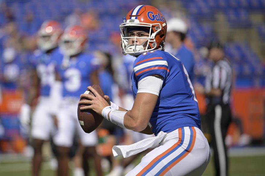 Florida quarterback Jalen Kitna (11) warms up before an NCAA college football game against Eastern Washington, Sunday, Oct. 2, 2022, in Gainesville, Fla. Florida backup quarterback Jalen Kitna, the son of retired NFL quarterback Jon Kitna, was arrested Wednesday, Nov. 30, 2022 and charged with two counts of distribution of child exploitation material and three counts of possession of child pornography. (AP Photo/Phelan M. Ebenhack, File)