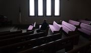 Pastor Rick Mannon sits for a photo among the pews at Calvary Assembly of God before a Bible study in Wilson, Wis., Wednesday, Nov. 16, 2022. (AP Photo/David Goldman)