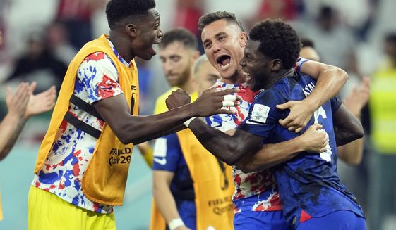United States&#39; Yunus Musah, right, Aaron Long, center, and United States&#39; goalkeeper Sean Johnson celebrate after defeating Iran in the World Cup group B soccer match between Iran and the United States at the Al Thumama Stadium in Doha, Qatar, Tuesday, Nov. 29, 2022. (AP Photo/Ashley Landis)